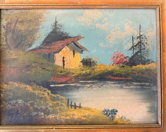 Paesaggio a olio in cornice dorata, firmato in basso