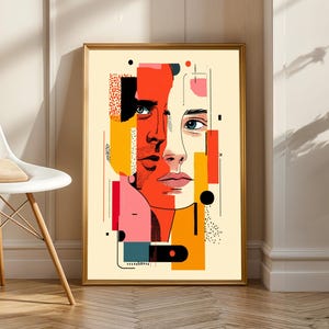 May include: Abstract art print featuring two faces, one male and one female, in a collage style. The artwork uses bold colors like red, orange, and pink, with geometric shapes and lines. The framed print is displayed on a wall next to a white chair.