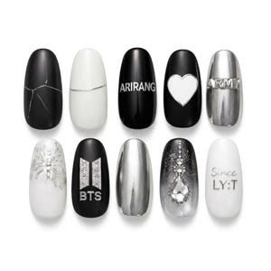 May include: A collection of ten artificial nails in black, white, and silver. Designs include text like "ARIRANG", "BTS", and "Since LY:T", along with a heart, butterfly, and marble effect. The nails are oval-shaped and have a glossy finish.