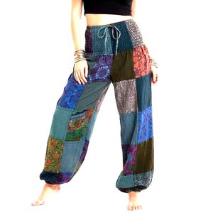 May include: Patchwork trousers featuring a high-waisted, smocked elastic waistband with a drawstring tie. The pants are constructed from various fabric panels in shades of blue, green, purple, and brown, displaying diverse floral and geometric patterns.