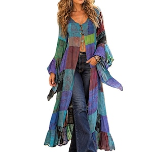 May include: A long, open-front duster cardigan featuring a patchwork design with various shades of blue, green, purple, and maroon. The garment has long, flared sleeves, a V-neckline with button closures, and is paired with dark blue denim flare jeans.