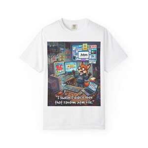 May include: White t-shirt featuring a cartoon fox with wide eyes, surrounded by computer screens displaying error messages and a virus warning. The text "I swear I didn't open that random .htm file" is below the image.