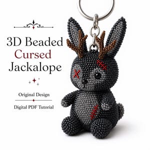May include: A 3D beaded jackalope keychain featuring dark gray and black beads, brown beaded antlers, and red stitched accents over one eye and on the chest. The text 3D Beaded Cursed Jackalope, Original Design, and Digital PDF Tutorial is visible.