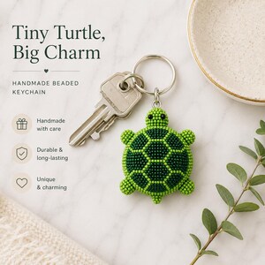 May include: A beaded turtle keychain featuring a dark green shell with light green accents and small black eyes. The turtle charm is attached to a silver metal keyring that holds a standard silver house key. The text Tiny Turtle, Big Charm is visible.