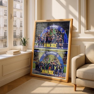 May include: A framed rectangular poster featuring two stacked sports celebration scenes. The top image shows a team under a blue arch with the text WINNERS and 31 MAI 2025. The bottom image shows a team under a blue arch with CHAMPIONS and 30 MAI 2026.