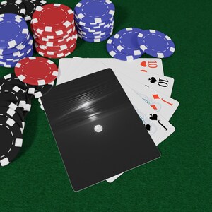 May include: Poker game scene with playing cards and poker chips. The cards show the number 10 in different suits. Stacks of red, blue, and black and white poker chips are arranged on a green felt surface.