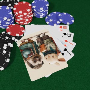 May include: A poker set with playing cards and poker chips. The playing cards feature an illustration of a hedgehog and a rabbit. Stacks of red, blue, and black poker chips are on a green surface.