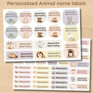 May include: Two sheets of personalised animal name labels. The labels feature various animal illustrations, including a hippo, lion, bear, deer, fox, hedgehog, and rabbit. Each label includes the name "Alexandra Abernathy". The labels are in pastel colours.