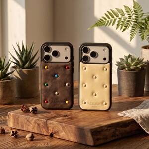 May include: Two phone cases with a food theme. One is brown with colorful dots and the text "Milk Chocolate". The other is beige with small circles and the text "Cheese Block". Both cases have a black border.