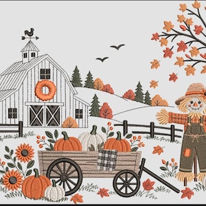 May include: An embroidery design featuring a white barn with a silo, a scarecrow in overalls, and a wooden wagon filled with orange and white pumpkins. The scene includes autumn trees with falling leaves, sunflowers, and a black bird.