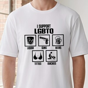 May include: White t-shirt featuring the text "I Support LGBTQ" above six black graphic icons: liquor, guns, beers, titties, and quickies. The shirt is made of a soft, lightweight material.
