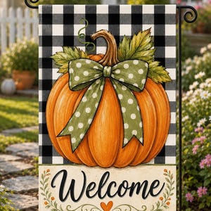 May include: A rectangular garden flag featuring a black and white buffalo check pattern background. A large orange pumpkin with green leaves and a green polka dot bow sits in the center. The bottom section is cream with the word Welcome in black script.