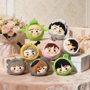 May include: A white ceramic mug with a black handle and the text "But First, Coffee" in a bold, black font. The mug is set against a blurred background, suggesting a cozy setting.