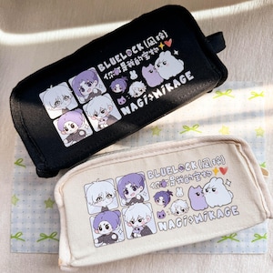 May include: Two rectangular pencil cases, one black and one beige, featuring anime-style character illustrations, the text "BLUELOCK" and "NAGI MIKAGE", and small animal graphics. The designs include four square portraits and two cartoon creatures.
