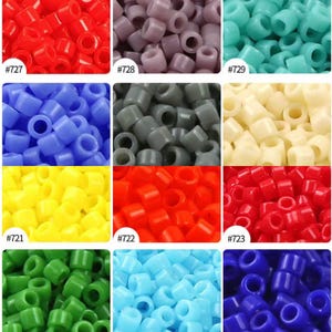 May include: A collection of small, cylindrical plastic pony beads in various solid colors including red, lavender, turquoise, blue, gray, cream, yellow, orange, green, light blue, and dark blue, each labeled with specific reference numbers.