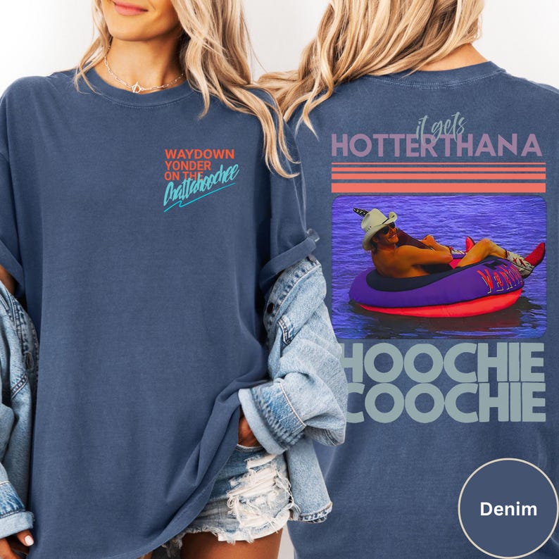 May include: Denim blue t-shirt with the text "Waydown Yonder on the Chattahoochee" on the front. The back features a graphic of a person in a tube with the text "it gets HOTTER THANA Hoochie Coochie".
