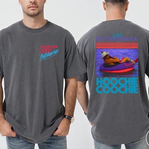 May include: Pepper-colored t-shirt with front text reading "WAYDOWN YONDER ON Chattahoochee" in red and blue. The back features a graphic of a person in a tube with the text "I AM HOTTER THAN A HOOCHIE COOCHIE".
