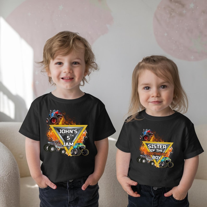 Puede incluir: Dos camisetas negras con tem&aacute;tica de monster truck. Una camiseta dice "John's 5th Jam" con un dise&ntilde;o de monster truck y llamas. La otra camiseta dice "Sister of the Birthday Boy" con un dise&ntilde;o similar.