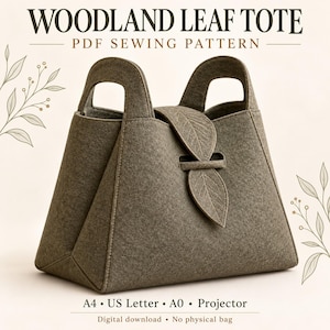 May include: A taupe felt tote bag with two integrated handles and a leaf-shaped closure flap. The text WOODLAND LEAF TOTE PDF SEWING PATTERN is displayed above, with A4, US Letter, A0, Projector, and Digital download text below.