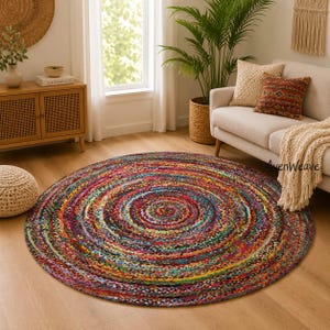 May include: A round, multi-colored braided rug featuring a concentric circular pattern. The rug is composed of tightly woven fabric strips in a vibrant mix of red, blue, yellow, green, and purple tones, creating a textured, multicolored surface.