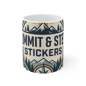 May include: A white ceramic mug featuring a graphic design with mountains, pine trees, and a compass. The text reads SUMMIT & STE STICKERS in dark blue lettering. The design includes a sun icon and a circular border on a light beige background.