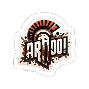 May include: A sticker with the word "ARTIGO!" in bold, stylized letters. The design includes a brown and orange helmet-like shape above the text, with brown splatters around the letters. The sticker has a white border.
