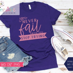 May include: A purple t-shirt with the text "you never fail until you stop trying" in pink lettering. The text is in a banner shape with a white outline.