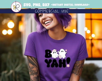 May include: Purple t-shirt with a black and white graphic of two ghosts with flowers and the text "Boo Yah!"