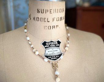 Charming Assemblage necklace of vintage carved flower, freshwater pearl, Mother of Pearl, and more!