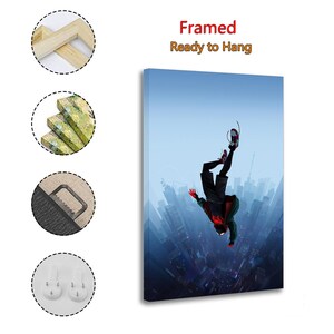 Puede incluir: Impresi&oacute;n art&iacute;stica en lienzo enmarcado que presenta una figura con un traje de superh&eacute;roe cayendo boca abajo contra un fondo de paisaje urbano. La obra de arte tiene una combinaci&oacute;n de colores azul y rojo, con el texto "Framed Ready to Hang".