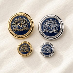 May include: Four round buttons featuring a deep blue center with a gold or silver embossed heraldic crest design. The crest depicts two lions flanking a shield with a bird, topped by a crown, and the Latin text INFIDEOFICIOQUEFORTIS.