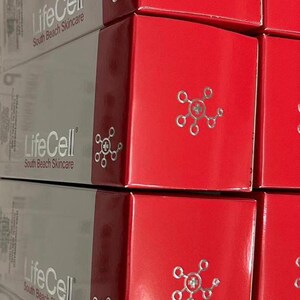 May include: Stacked boxes of LifeCell South Beach Skincare products. The boxes are red and gray, with the brand name and logo printed on them. The boxes have a glossy finish.