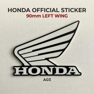 May include: A Honda official sticker featuring a white left wing graphic with black outlines and the word HONDA in black capital letters. The sticker includes the text 90mm LEFT WING and A03, indicating a width of 90mm for this specific decal.