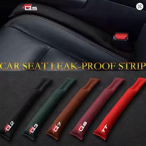 May include: Car seat leak-proof strips in black, green, brown, burgundy, and red. Each strip has a white logo with a red outline. The text "CAR SEAT LEAK-PROOF STRIP" is displayed in gold.