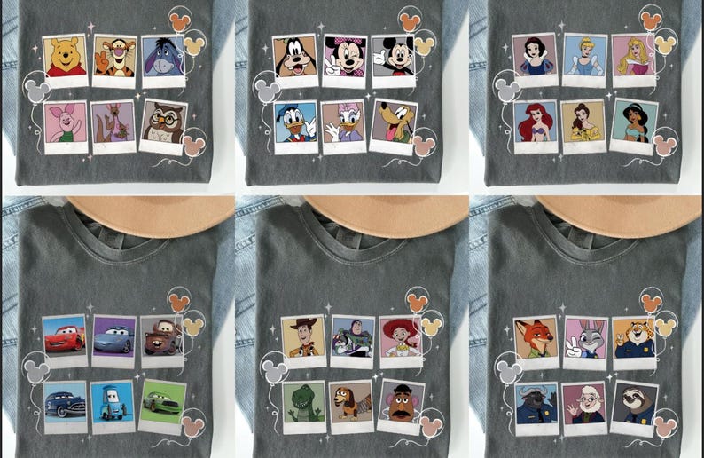 May include: Gray t-shirts featuring various Disney character designs. Each shirt showcases a collection of characters in a polaroid-style arrangement, with Mickey Mouse ears and decorative elements. The shirts are displayed on a denim background.