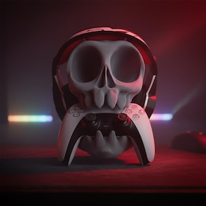 Può includere: Un teschio grigio con cuffie da gioco bianche e nere, che tiene in bocca un controller di gioco bianco e nero. Lo sfondo è rosso scuro con una luce al neon.