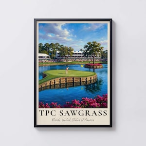 May include: A framed poster featuring a golf course scene with a green island surrounded by blue water, pink flowers in the foreground, and a large building in the background. The text reads TPC SAWGRASS Florida, United States of America.