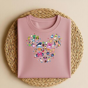 May include: A white ceramic mug with a black handle and the text "But First, Coffee" in a handwritten style. The mug is on a white surface. The mug is approximately 10 cm tall.