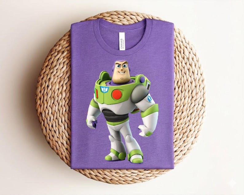 May include: A purple t-shirt featuring a graphic of Buzz Lightyear from Toy Story. The character is depicted in his signature green, white, and purple spacesuit. The shirt is displayed on a woven, circular placemat.