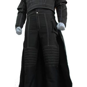 May include: Black costume with white stitching details. The outfit includes a long coat, a top with vertical stitching, and pants with knee padding. The costume is displayed on a mannequin.