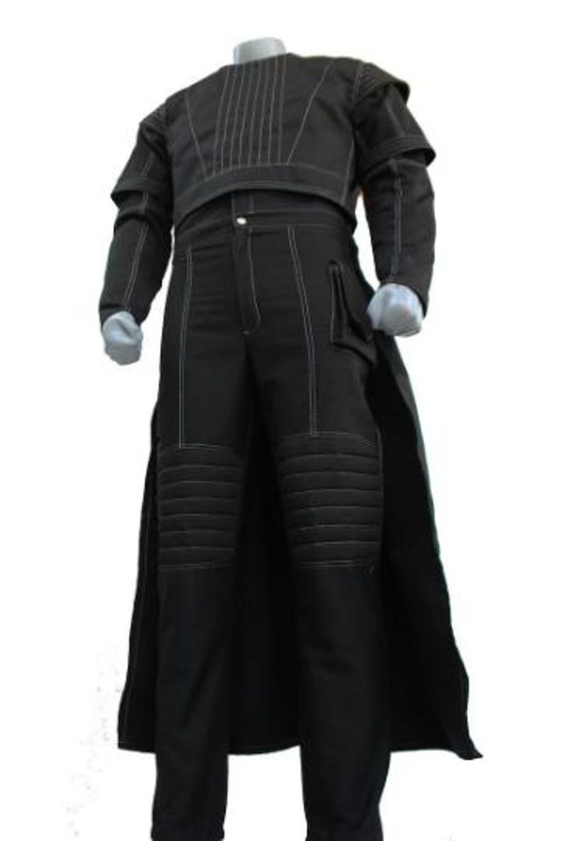 May include: Black costume with white stitching details. The outfit includes a long coat, a top with vertical stitching, and pants with knee padding. The costume is displayed on a mannequin.