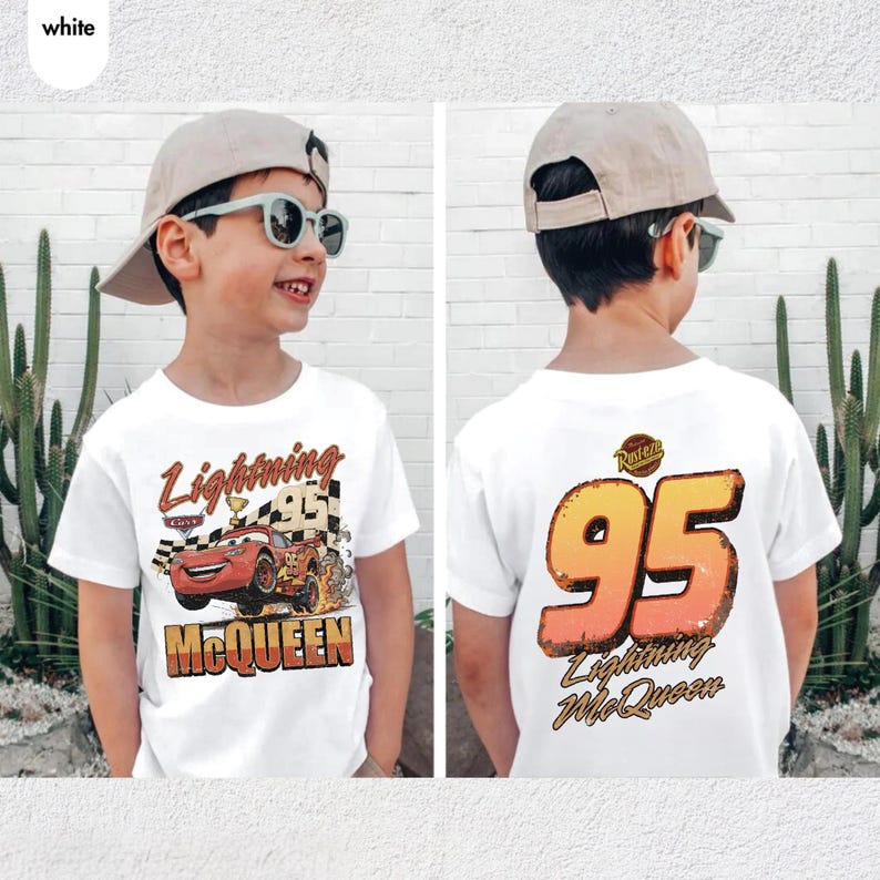 Pu&ograve; includere: T-shirt bianca con Lightning McQueen del film Cars. La parte anteriore presenta il testo "Lightning McQueen" e un design di auto da corsa. Il retro mostra il numero "95" e il testo "Lightning McQueen".