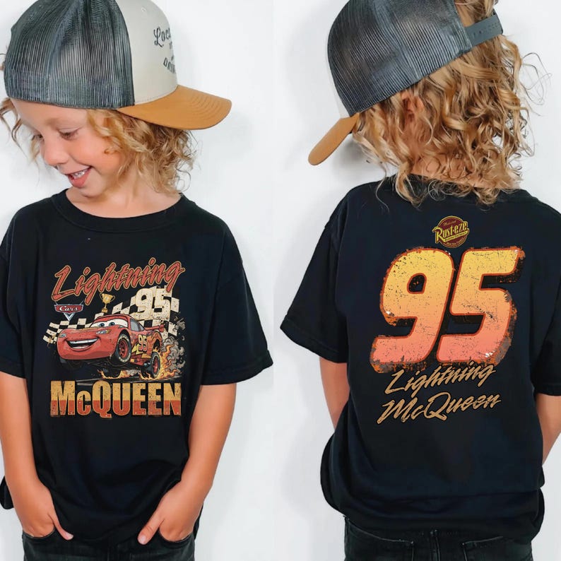 May include: Black t-shirt featuring Lightning McQueen from the Cars movie. The front graphic shows the character with the text "Lightning McQueen" and "95". The back of the shirt displays "95" and "Lightning McQueen".