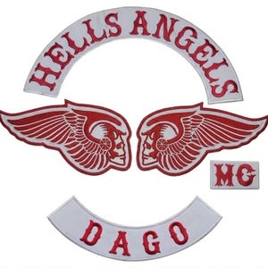 May include: A set of embroidered patches featuring the words "HELLS ANGELS" in red on a white arched background. Includes two winged skull patches and a smaller "MG" patch, plus a patch that says "DAGO".