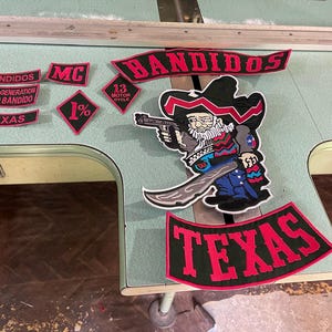 May include: A white ceramic mug with a black handle and the text "But First, Coffee" in a black, bold font. The mug is on a white surface.