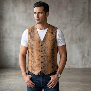 May include: A sleeveless vest featuring a tan and brown snakeskin pattern, a V-neckline, and a five-button front closure. The garment is worn over a plain white short-sleeved t-shirt paired with dark blue denim jeans and a brown leather belt.