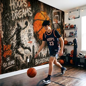 May include: A basketball-themed room featuring a large wall mural with the text HOOPS & DREAMS, PLAY HARD OR GO HOME, and NO DAYS OFF. The mural depicts a basketball player silhouette, a city skyline, and a large orange basketball.