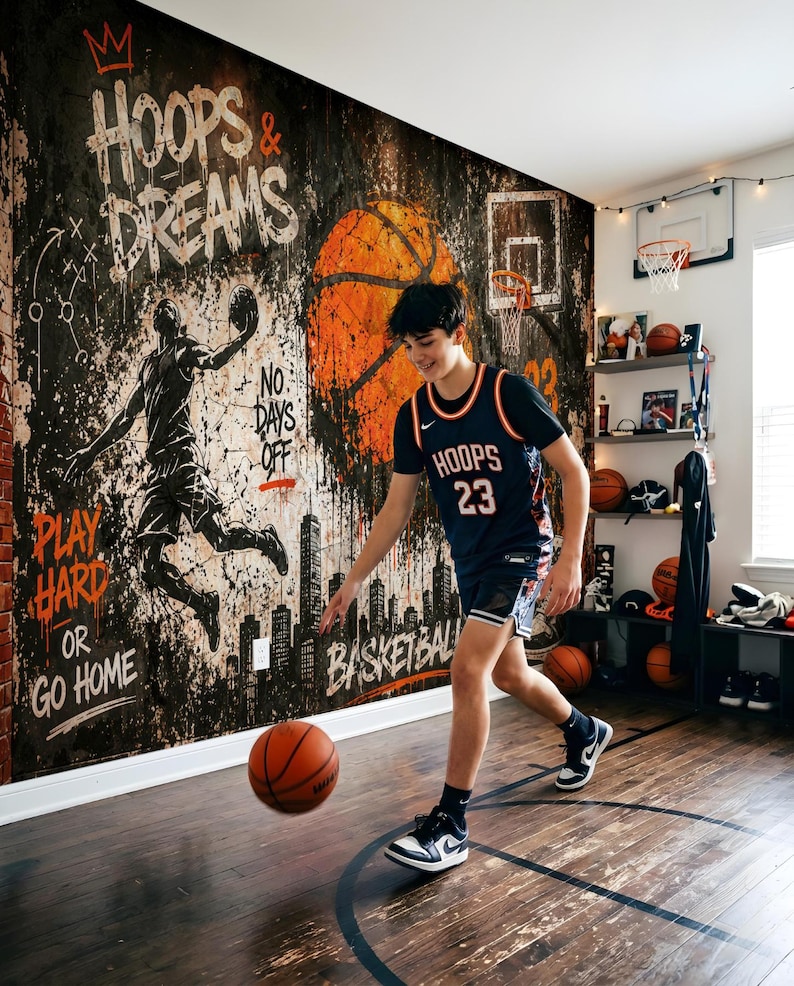 May include: A basketball-themed room featuring a large wall mural with the text HOOPS & DREAMS, PLAY HARD OR GO HOME, and NO DAYS OFF. The mural depicts a basketball player silhouette, a city skyline, and a large orange basketball.