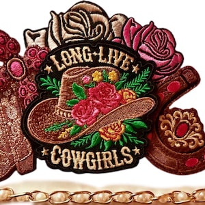 May include: An embroidered patch featuring a brown cowboy hat adorned with red and yellow roses, surrounded by a brown cowboy boot, a horseshoe, and additional roses. The text LONG LIVE COWGIRLS is stitched in white on a black background.
