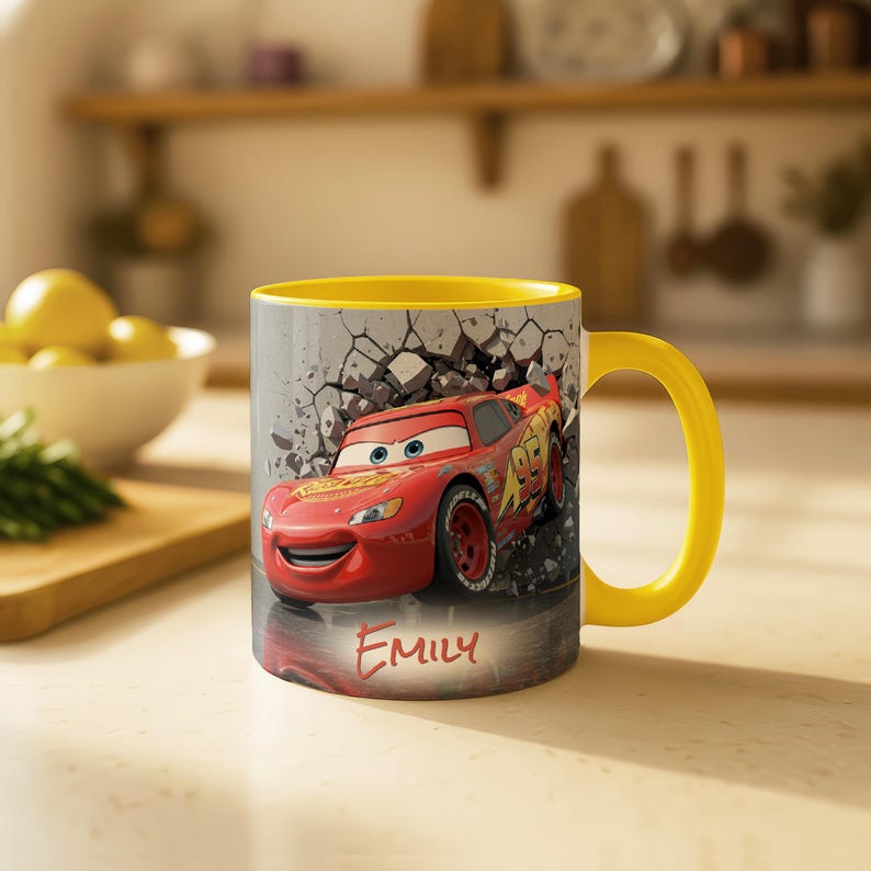 May include: A yellow-handled mug featuring Lightning McQueen from the Cars movie, bursting through a cracked wall design. The mug has a yellow interior and the name "Emily" is written on the front.